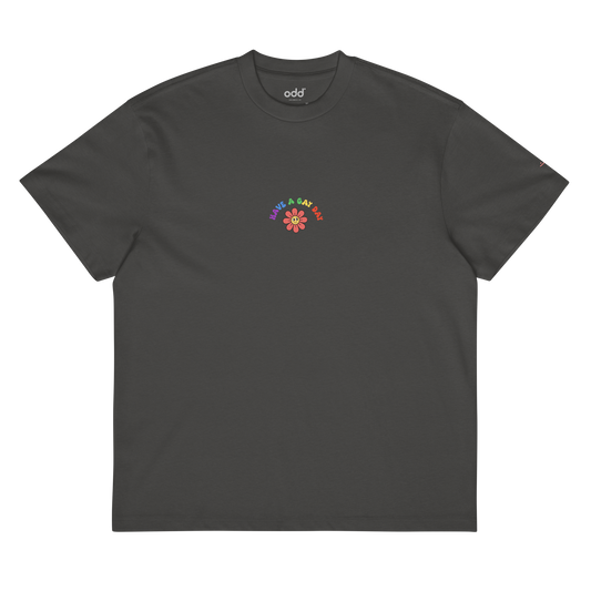 vintage black boxy oversized unisex t-shirt, front view, colorful "HAVE A GAY DAY" and friendly looking flower print