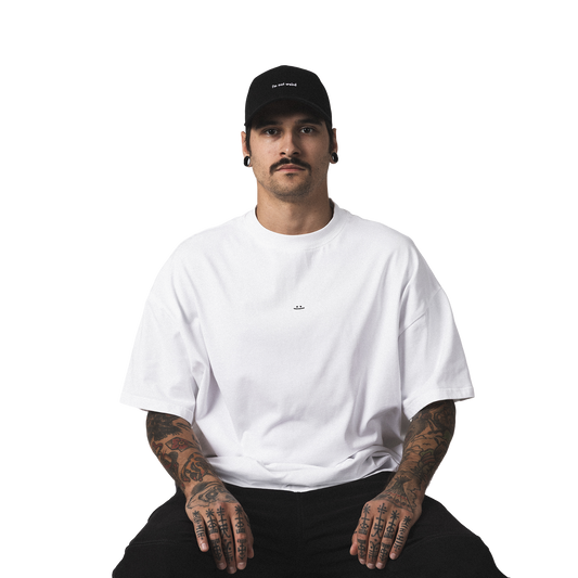 Minimalist black cap with embroidered I'm not weird design streetwear style model front view