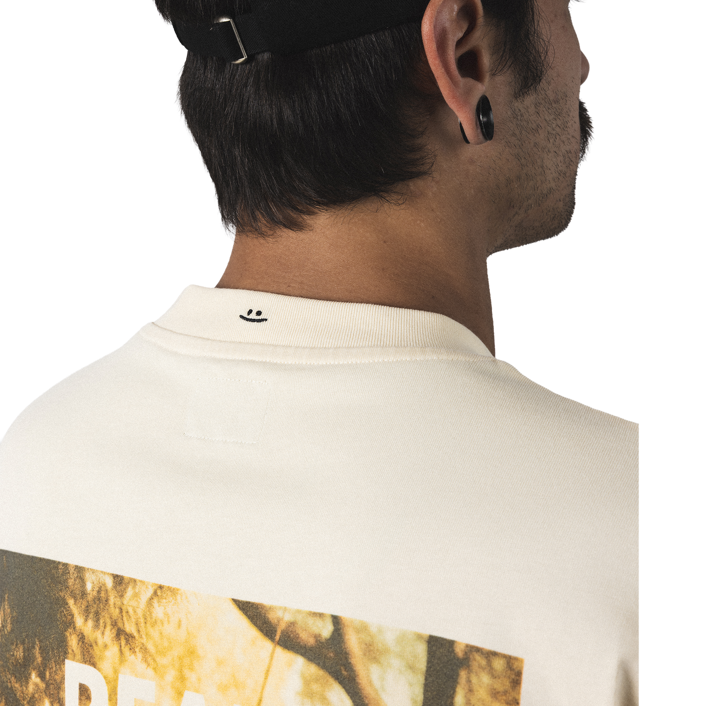 Oversized heavy cotton t-shirt back closeup model view minimalist peak male form design back print with smiley embroidery