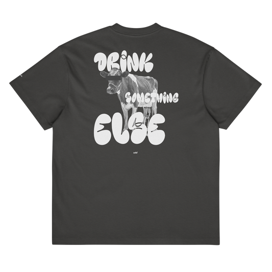 vintage black boxy oversized unisex t-shirt, back view, "DRINK SOMETHING ELSE" and dairy cow print