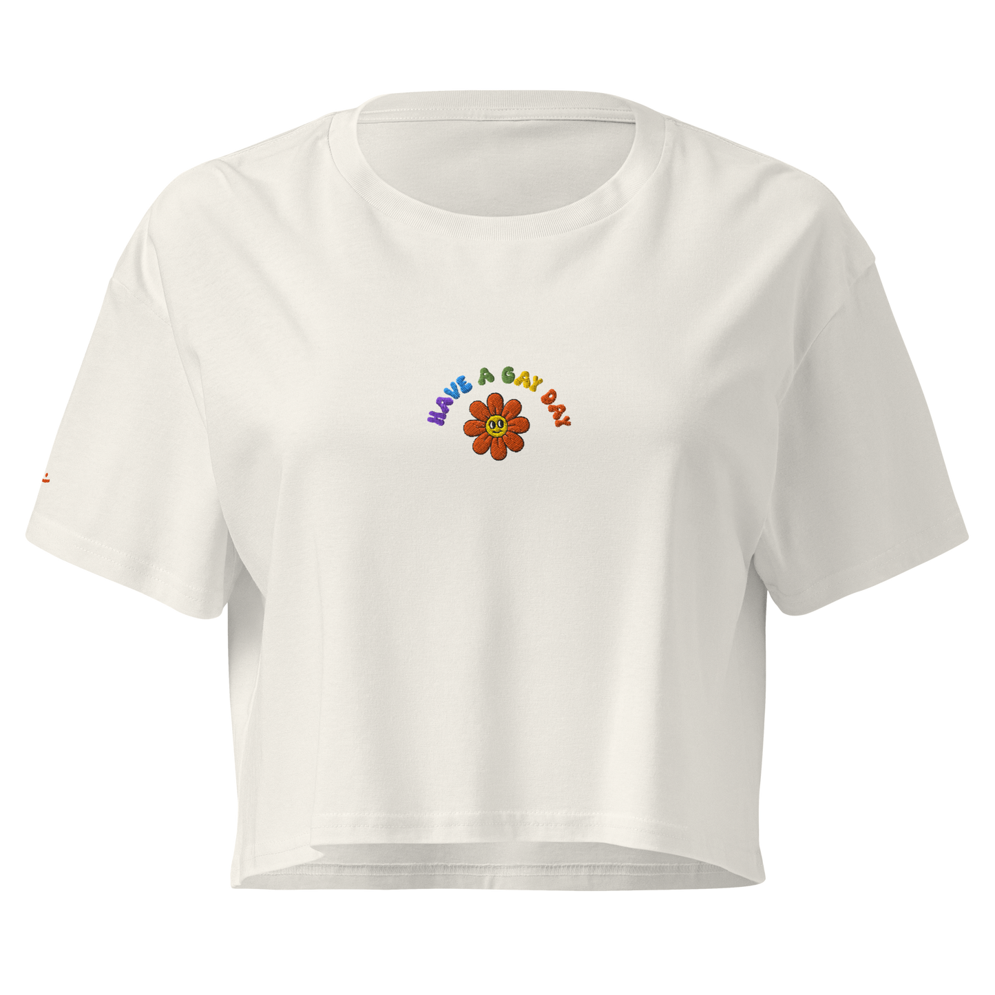 Off-White crop top, front view – small colorful"have a gay day" and flower with friendly face embroidery on chest