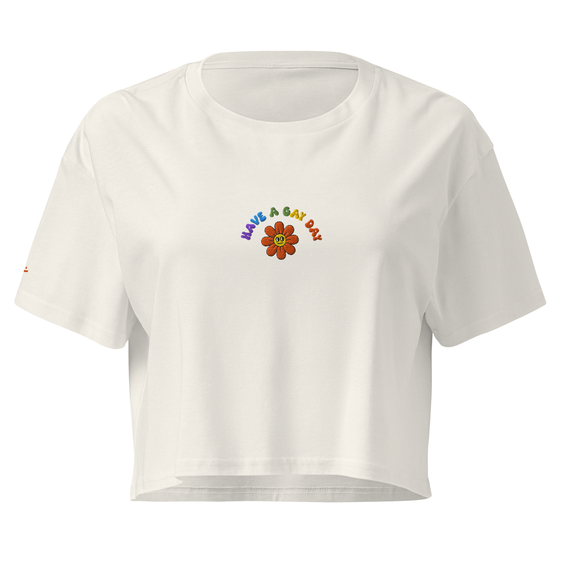 Off-White crop top, front view – small colorful"have a gay day" and flower with friendly face embroidery on chest